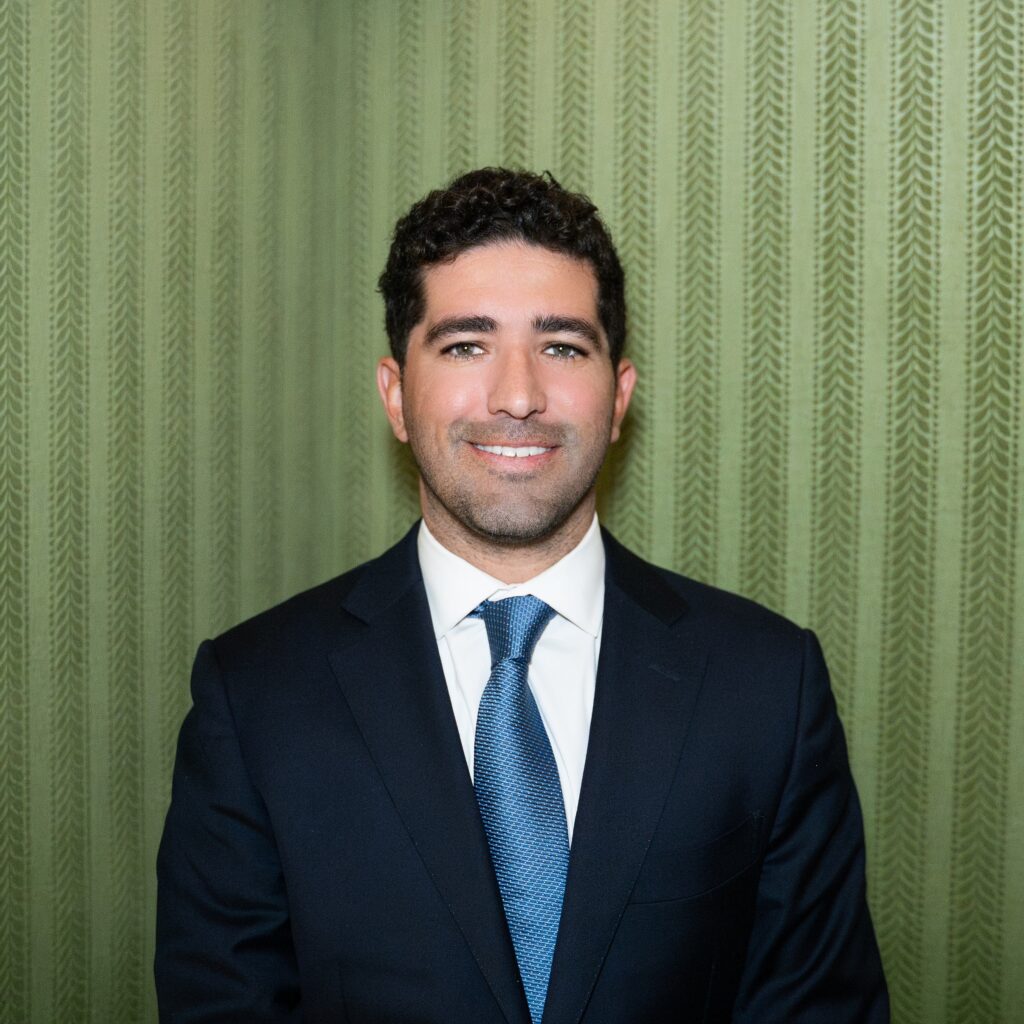 Vice President Josh Anchondo Vice President Josh Anchondo, a man in a dark suit and blue patterned tie, smiles.